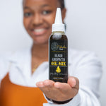 A smiling woman holds a bottle of Hair Growth Oil Mix, presenting it toward the camera. The black and gold bottle label emphasizes the product's benefits for healthy, shiny, voluminous hair. The woman’s hand is in focus, showcasing the oil, while her blurred figure in the background adds a warm, inviting feel to the image
